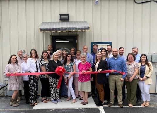 PCCM board members and volunteers join with the McMinnville Chamber of Commerce representatives for the ribbon cutting ceremony held at PCCM's new location.